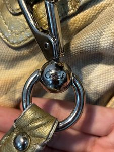 Chic Coach Shoulder Bag with Gold Accents