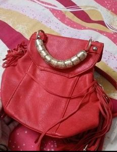 Chic Red Handbag with Gold Accent Handle