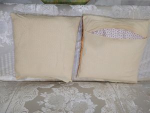 A set of two cushion covers