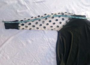 Chic Black Top with Polka Dot Sleeves