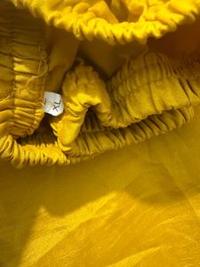 Elegant Yellow Kurti pant with Intricate Neckline