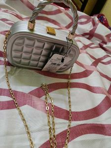 Elegant Silver Clutch with Gold Chain