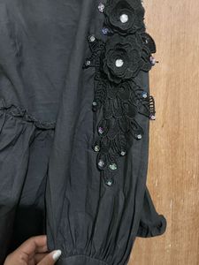 Chic Black Peplum Top with Embellishments