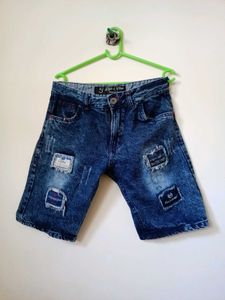Casual distressed blue denim shorts.