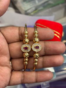 Elegant Gold Toned Earrings with Red Stones