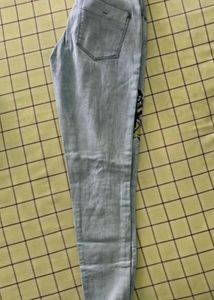 Denim jeans with flower pattern stitched on it