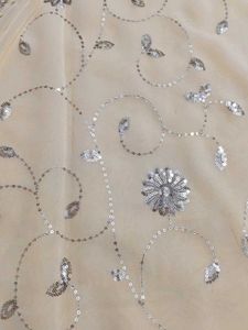Elegant Cream Saree with Silver Embellishments