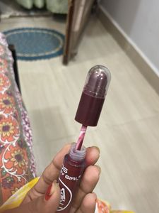matte liquid lipstick with lip cryon on tip.