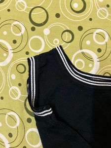 Sleeveless Black Top with Striped Neckline
