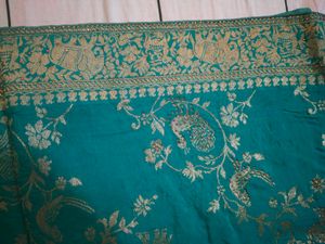 Elegant Teal Saree with Gold Peacock Motif
