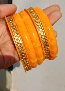 Vibrant Orange Bangle Set with Golden Embellishmen