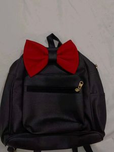 Black Backpack with Red Bow