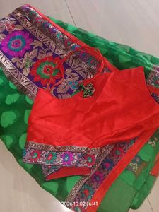 a printed saree with net in green color which look