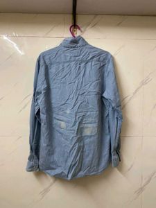 A MILDLY BLUE FADED DENIM SHIRT