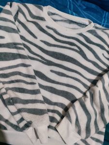 White Velvet Sweater With Black Stripes On It