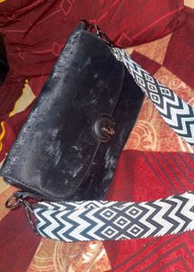 Stylish Black Crossbody Bag with Patterned Strap