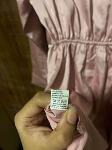 Imported satin finish twist front dress.