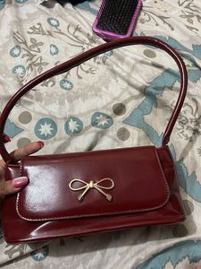 Chic Burgundy Patent Bow Clutch
