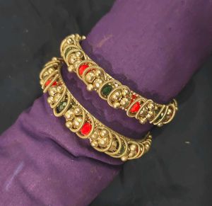 Silver tone Bangles: Red and green details.