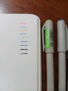 Assorted Pens and Notebook