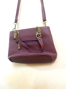 Chic Maroon Handbag with Gold Chain Accents