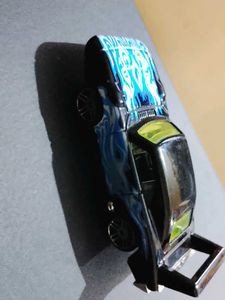 Black hotwheels Car with blue Flames
