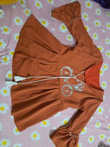 Cute Orange Peplum top with Bicycle Print