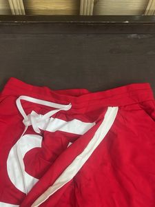 Red Wide-Leg Pants with Bold White Text