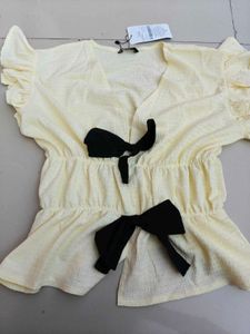 Cream Textured Peplum Top with Bows