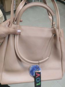 Stylish Beige Handbag with Pom-Pom Charm