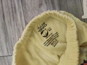 Bundle of baby clothes, beanie, shoes.