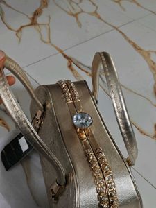 Elegant Gold Clutch with Gemstone Accent