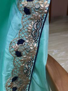 Elegant Teal Saree with Intricate Border