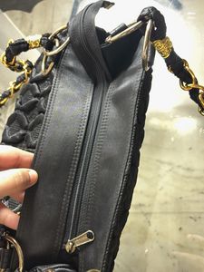 Stylish Black Textured Bag with Gold Emblem