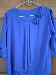 Charming Blue Pleated Blouse with Floral Accents