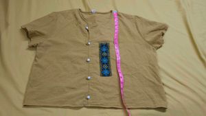 mustard-colored, short-sleeved top