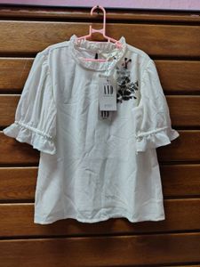 New Tag Chic White Top with Embellishm