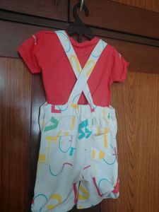 white dungaree with orange tshirt