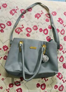 Stylish Grey Tote Bag with Pom-Pom Accent