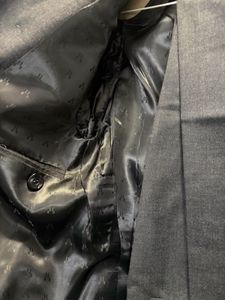 A crisp dark grey custom tailored suit