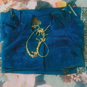 Elegant Teal Saree with Gold Embellishments