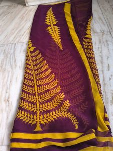 Vibrant burgundy and yellow leaf saree