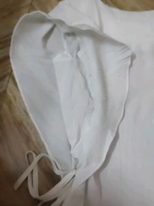 White Top With Shoulder Frill And Knot Style.