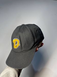 Black baseball cap with yellow 'D' logo