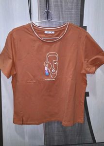 Orange Graphic T-Shirt with Ripped Jeans