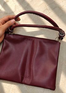 Clinique burgundy Leather Bag.