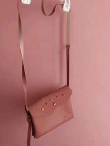 Peach Colour Sling Bag With 2 zips Can Carry Mobile ,wallet Cards And Make Up Items.