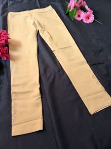 Elegant Beige Leggings with Embroidered Hem