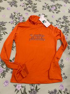 Orange Turtleneck Graphic Top