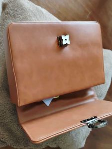 Stylish Tan Handbag with Flower Clasp